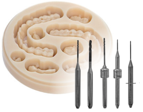 PMMA dental puck showing bridges that have been milled, with selection of Diamond Coated carbide dental milling burs